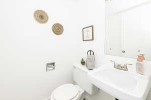 Half bath featuring a sink and toilet