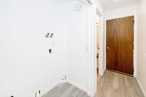 Washroom featuring light wood-style floors and washer hookup