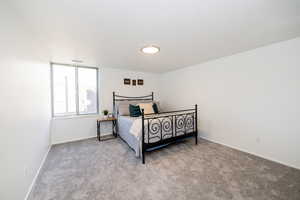 Bedroom featuring carpet and baseboards