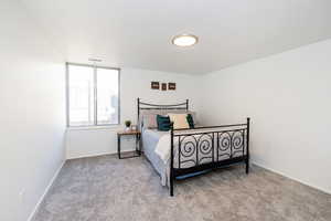 Carpeted bedroom featuring baseboards