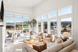 Sunroom featuring a high ceiling, a mountain view, and recessed lighting