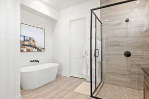 Bathroom with a freestanding tub and a stall shower