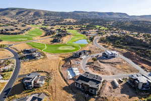 Aerial overview of property's location featuring a water and mountain view and nearby suburban area