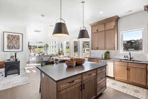Kitchen featuring tasteful backsplash, a kitchen island, open floor plan, healthy amount of natural light, and recessed lighting