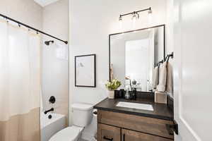 Bathroom featuring shower / tub combo with curtain and vanity