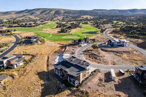Bird's eye view of a golf course and a water and mountain view