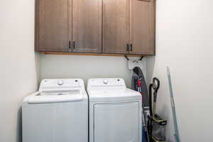 Laundry room with washer and dryer and cabinet space