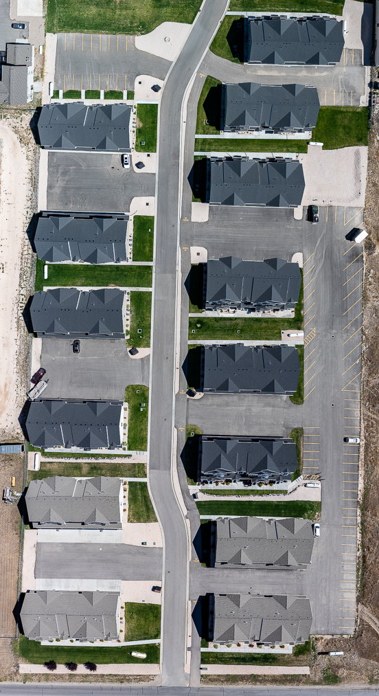 Aerial view of property and surrounding area with nearby suburban area