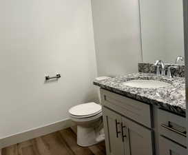 Bathroom with vanity and dark wood-type flooring and shower