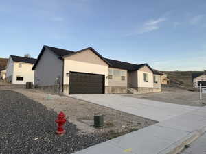 View of front of home with driveway, a garage, and vinyl siding