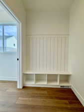 Mudroom with wood finished floors and baseboards