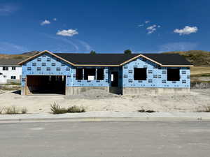 Under construction with driveway, a garage, and a mountain view