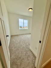 Bedroom with light carpet and baseboards