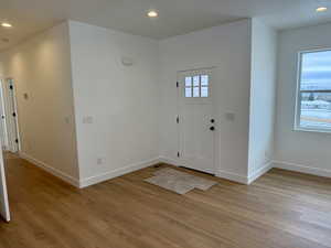 Entryway with recessed lighting and light wood finished floors