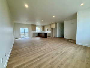 Unfurnished living room with recessed lighting and light wood-type flooring