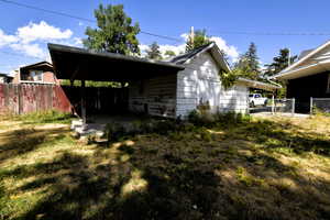 View of side of home with a patio area and a carport