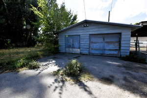 Detached garage with asphalt driveway