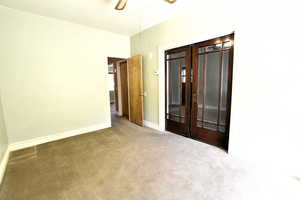 Unfurnished bedroom with carpet floors and ceiling fan