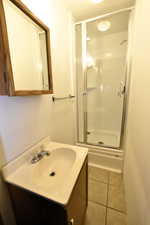 Bathroom featuring vanity, a shower stall, and light tile patterned floors