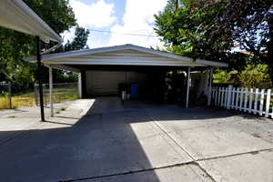 Garage featuring a detached carport