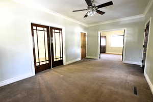 Unfurnished room featuring crown molding, carpet floors, french doors, and ceiling fan