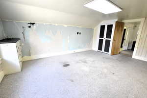 Bonus room with lofted ceiling and carpet floors