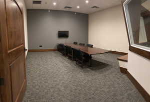 Home office featuring a paneled ceiling, dark colored carpet, and recessed lighting