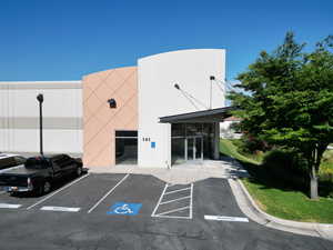 View of property with uncovered parking