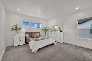 Bedroom with light carpet and recessed lighting