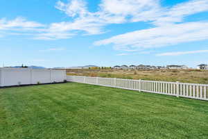 Fenced backyard with a mountain view