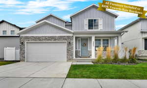 Craftsman house with a porch, board and batten siding, stone siding, and concrete driveway