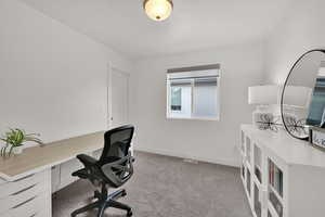 Office area featuring baseboards and light colored carpet
