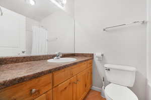 Full bath with vanity, light tile patterned floors, and a shower with curtain