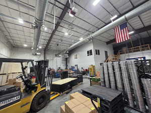 Garage featuring metal wall and a garage door opener