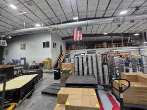 Garage featuring metal wall and a workshop area