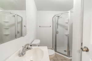 Bathroom featuring a stall shower and light tile patterned floors