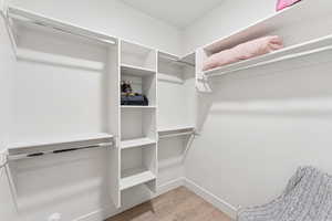 Walk in closet featuring light wood-type flooring