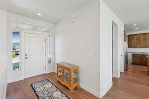 Entryway featuring a textured ceiling, dark wood finished floors, and recessed lighting