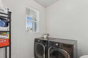 Washroom featuring separate washer and dryer and a textured ceiling