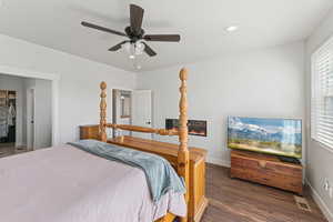 Bedroom featuring dark wood-style flooring, a spacious closet, a ceiling fan, a textured ceiling, and recessed lighting