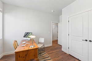 Office space featuring dark wood finished floors and a textured ceiling