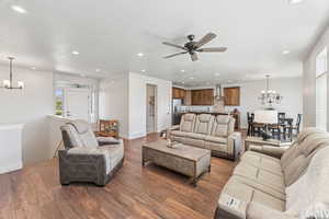 Living area featuring a chandelier, wood finished floors, recessed lighting, a textured ceiling, and ceiling fan