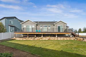 Rear view of property with a wooden deck and stairs