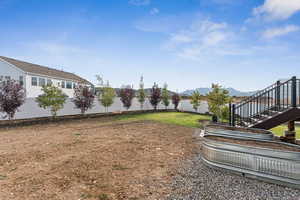 Fenced backyard featuring a mountain view and stairs