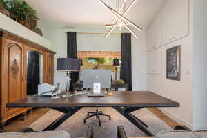 Office with light wood-type flooring and baseboards