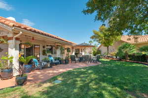 View of grassy yard featuring a patio area