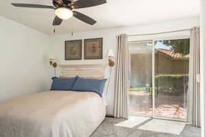 Bedroom with carpet floors, access to outside, and a ceiling fan