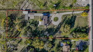 Aerial view of property and surrounding area featuring property boundaries highlighted