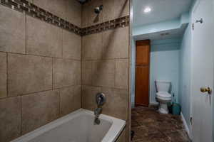 Full bath featuring shower / bathtub combination and recessed lighting