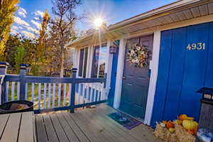Entrance to property featuring a wooden deck